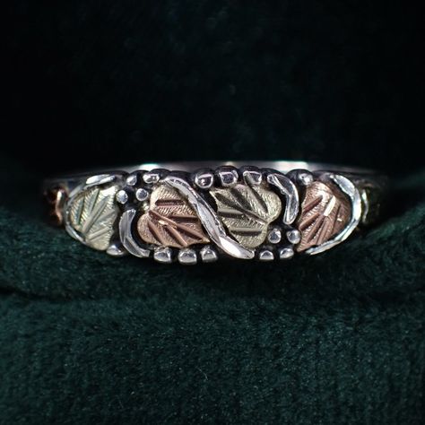 This beautiful little treasure is a sterling silver & 12K black hills gold stacker style ring. It features the well known black hills gold tri-color grape and leaf design. The setting measures approx. 3/16" tall. It's a size 8 and weighs 1.88 grams. #vintagejewelry #vintage #sterlingsilver #blackhillsgold #grape #leaf #stacker #pinky #ring #nostalgia #justlisted #purchasenow #sawdustfinery #familybusiness #womeninbusiness #smallbusiness #shopsmall #etsyseller #etsy Black Hills Gold Rings Vintage, Gold Rings Vintage, Black Hills Gold Rings, Grape Leaf, Black Hills Gold, Black Hills, Pinky Ring, Leaf Design, Tri Color