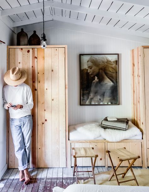 Pine Wardrobes  In lieu  of a closet, the couple built a pair of pine wardrobes that flank a built-in bench and the self-portrait of a friend, another prized piece. “I met her when we were both working on a paint crew to make ends meet,” Velvick says. He sent monthly installments of $50 to the artist for years to buy it at a fair price. Built In Banquette Seating, Wardrobe Light, Pine Wardrobe, Window Nook, Wood Cabin, Built In Banquette, Narrow Rooms, Seattle Homes, Build A Closet