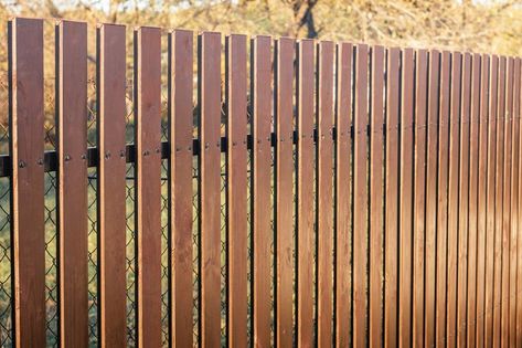 How to Convert a Chain-Link Fence to a Wood Fence | Hunker Corrugated Metal Privacy Fence, Metal Fence Ideas Steel, Diy Metal Fence, Metal Fence Design, Metal Fence Ideas, Metal Privacy Fence, Chain Link Fence Privacy, Yard Fencing, Corrugated Metal Fence