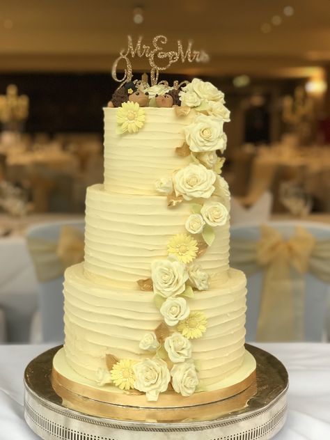 Wedding Cake. Buttercream covered with sugar flowers and hedgehog topper. Bottom tier chocolate sponge with white chocolate buttercream, middle tier sticky ginger sponge with ginger buttercream and butterscotch sauce, topped with red velvet cake with a fresh cream cheese filling. Acrylic name topper Ginger Buttercream, Wedding Cake Buttercream, Yellow Wedding Cake, Cream Wedding Cakes, 3 Layer Cakes, Tier Cakes, Butterscotch Cake, White Chocolate Buttercream, Three Tier Cake