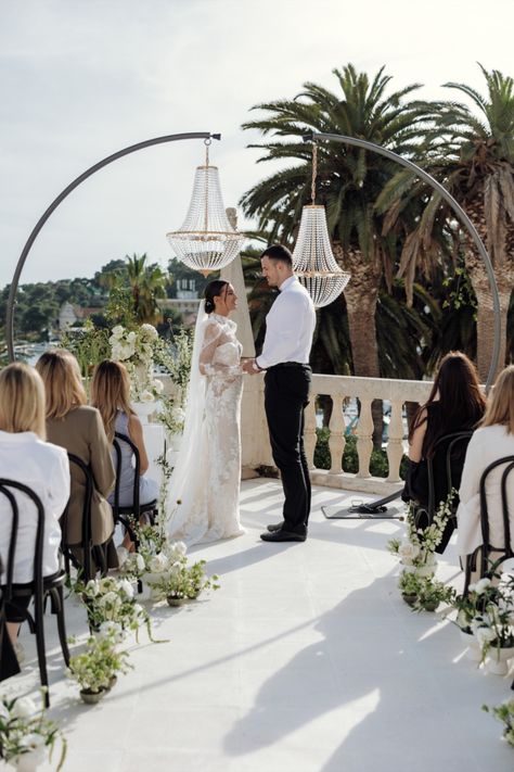 Utilizing the same chandeliers that they would later use for the reception tables, Klaudia Popic, and team, created a unique crystal chandelier alter like we've never seen before. Whimsical white floral arrangements lined the aisle and the beautiful Croatian skyline served as the backdrop for a romantic ceremony. Chandelier Wedding Ceremony, Wedding Candelabras Ceremony, Outdoor Wedding Ceremony Chandelier, Candle Wedding Alter Ceremony Backdrop, Hanging Ceremony Installation, Wedding Ceremony Tree Florals, Romantic Ceremony, White Floral Arrangements, Crystal Altar