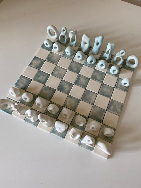 Pre-orders ship 4-7 weeks from date of purchase. A playable showpiece chess set. Hand sculpted in porcelain. Board is made up of individual tiles 1 5/8 x 1 5/8*. Original design. Chess pieces are annotated on the bottom. *measurements are approximate Flat Chess Pieces, Handmade Clay Chess Set, Cute Chess Set, Ceramic Chess Pieces, Chess Pottery, Clay Chess Board, Unique Chess Sets, Chess Ceramic, Clay Chess Set