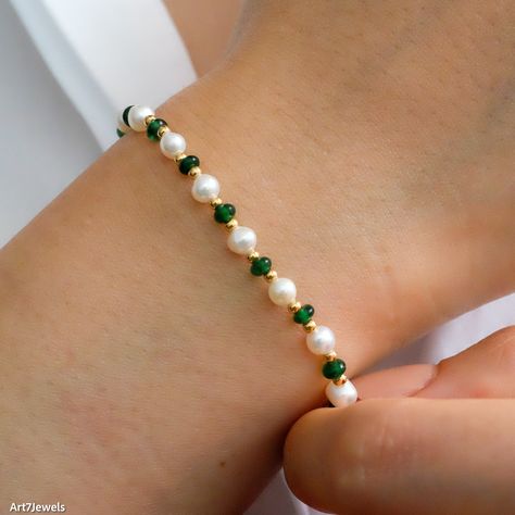 Delight her with our Dainty Emerald & Pearl Beaded Bracelet, featuring vibrant green emeralds, lustrous freshwater pearls, and delicate gold beads. This sophisticated bracelet complements any outfit, making it perfect for any occasion from birthdays to special celebrations. Its adjustable design ensures a comfortable fit for any wrist size. Packaged in an elegant gift box, it's ready to be gifted and cherished, embodying elegance and grace. DETAILED DESCRIPTION// Material:  925 sterling silver Green And Gold Beaded Bracelets, Emerald And Pearl Bracelet, Green Pearl Bracelet, Emerald Green Bracelet, Fancy Beaded Bracelets, Elegant Beaded Bracelets, Dainty Beaded Bracelets, Green Bracelet Beads, Green Bracelet Ideas