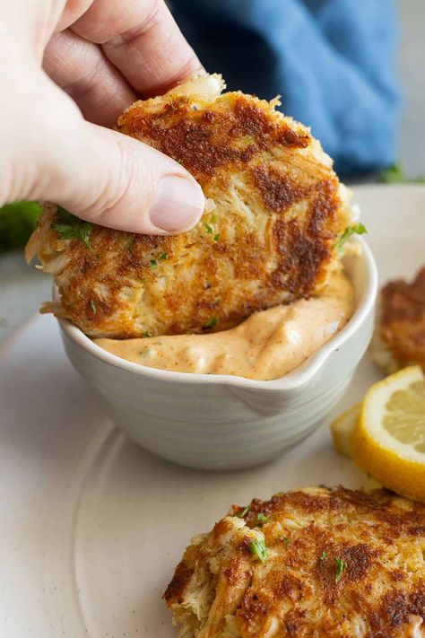 A crab cake being dipped into the remoulade sauce. Crab Cake Remoulade Sauce, Crab Cake Dipping Sauce, Crab Cake Dip, Crab Dipping Sauce, Seafood Fries, Crab Cake Remoulade, Crab Cake Burgers, Crab Cake Sauce, French Sauces