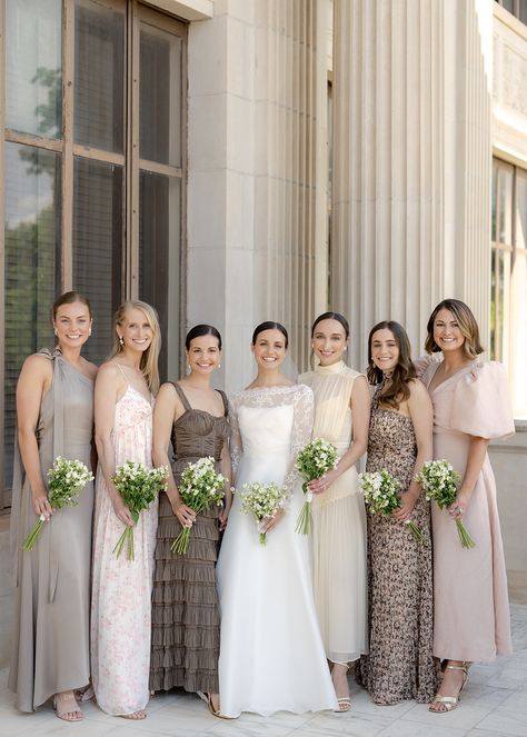 Bridesmaids standing with bride on wedding day wearing mismatched neutral dresses Winter Wedding Mix And Match Bridesmaids, Gold Mix And Match Bridesmaid Dresses, Earthy Neutral Bridesmaid Dresses, Bridesmaids Dresses Earth Tones, Taupe Bridesmaid Dresses Mismatched, Wedding Party Neutral Colors, Neutral Tone Bridesmaid Dresses, Dark Neutral Bridesmaid Dresses, Matching Bridesmaids And Groomsmen