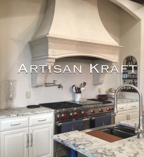 Rustic kitchen range hood made from cast stone in a kitchen with over a stove range. Marble counter top with a marble counter top island. Stainless steal faucet and a stainless steal pot filler faucet over the range. Cast Stone Range Hood, Oven Hoods, Limestone Kitchen, Stone Range Hood, Kitchen Hood Vent, Kitchen Range Hoods, Lakehouse Kitchen, Stove Hood, Kitchen Hood Design