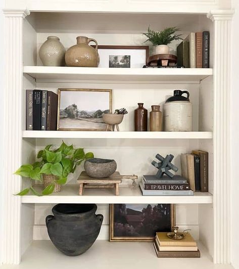 20 Transitional Shelf Styling Ideas » Lady Decluttered Home Office Shelf Styling, Picture Frame Styling Shelves, Vintage Vase Decorating Ideas, Office Shelf Decor Men, Book Case Styling Ideas, Amber Lewis Shelf Styling, Earthy Bookshelf Decor, Modern Vintage Shelf Decor, Top Of Built Ins Decor