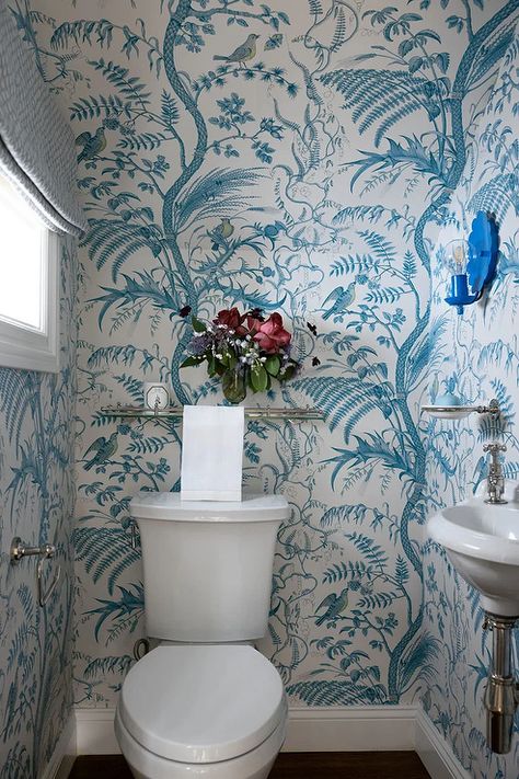 Brunschwig & Fils Bird And Thistle Aqua Wallpaper accents a powder room featuring a glass and nickel shelf fixed above a white porcelain toilet. Bathroom Tile Half Wall, Bird And Thistle Wallpaper, Traditional Bathroom Design Ideas, Bird And Thistle, Blue Trellis Wallpaper, Wallpaper Accents, Chinoiserie Bathroom, Beadboard Trim, Traditional Bathroom Design