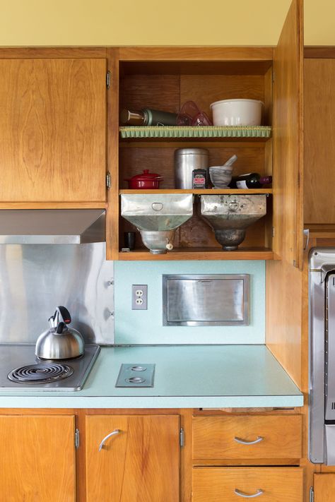 House Tour: A Restored Mid-Century Home in Rhode Island | Apartment Therapy Vintage 60s Kitchen, Amber Shellac Cabinets, Mcm Painted Kitchen Cabinets, Retro Kitchen Island, Mcm Kitchen Cabinets, Midcentury Modern Kitchen Cabinets, Mid Century Kitchen Cabinets, Mustard Kitchen, Therapy Photo