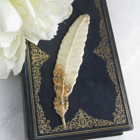 Feather bookmark, cream and gold resin feather bookmark, book lover's gift, Mother's day gift, gift for sister or mum, bookworm gift Indulge in the elegance of this stunning cream and gold resin feather bookmark. Carefully handcrafted with a blend of high-quality materials, this bookmark is not only visually appealing but also built to withstand daily use. Its unique design sets it apart from other bookmarks on Etsy, making it a charming gift for bookworms and a delightful addition to any bo... Feather Bookmark, Gift For Sister, Gifts For Bookworms, Cream And Gold, Charm Gift, Book Lovers Gifts, Sister Gifts, Mother's Day Gift, Book Worms