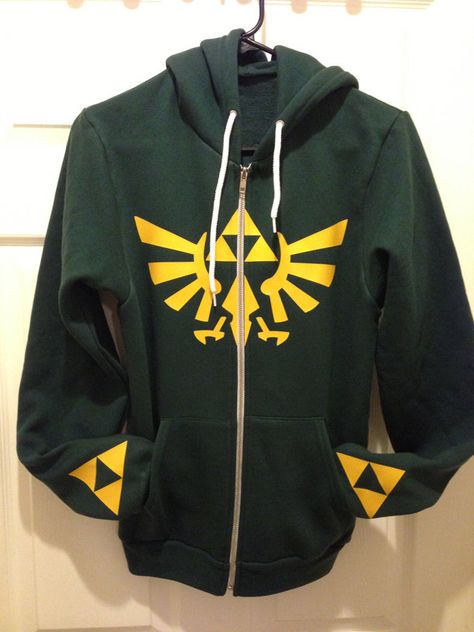 Legend of Zelda Triforce Hoodie Zelda Hoodie, Hylian Crest, Legend Of Zelda Triforce, Zelda Triforce, Geeky Clothes, Internet Games, Link Zelda, Geek Fashion, Gaming Room