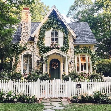 Cottagecore heart is full! 🏡💕 This dreamy abode with its white picket fence, floral accents, and stone chimney is pure magic. Bay windows, cozy porch, and ivy-covered walls create the coziest atmosphere. Pastel colors, vintage details, and a garden path leading to endless possibilities. #cottagecore #dreamhome #countryliving #homegoals #vintagevibes #gardenlife White Picket Fence House Dream Homes, Houses With Picket Fences, Front Yard Landscaping Victorian Home, Cottage With Lots Of Windows, Cottagecore Farmhouse Exterior, Dream Cottage Exterior, Houses With Vines, Vintage House Aesthetic Exterior, Old Vintage House Exterior