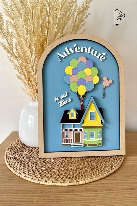 Add some Disney magic to your collection with this fun wood adventure is out there sign featuring the house from the movie Up. Measuring 12" x 8 1/2" x 1/2", this sign is a perfect addition to any home or office. Made of 1/8" MDF wood and featuring pastel colors, this sign is suitable for both kids and adults alike. The sign is inspired by the adventurous spirit of Carl and Ellie, making it a great gift for fans of all ages. Creative Photo Gifts, Diy Engagement Gifts, Carl And Ellie, Disney House, Wood Laser Ideas, Up Movie, Movie Room Decor, Diy Laser Cut, Disney Sign