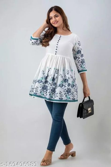 Checkout this latest Tops & Tunics Product Name: *Bright Floral Print Cotton Flared Top* Fabric: Cotton Sleeve Length: Three-Quarter Sleeves Pattern: Printed Net Quantity (N): 1 Sizes: S, M (Bust Size: 38 in, Length Size: 34 in) L (Bust Size: 40 in, Length Size: 34 in) XL (Bust Size: 42 in, Length Size: 34 in) XXL (Bust Size: 44 in, Length Size: 34 in) XXXL This floral print top is a great addition to your wardrobe. Whether you're wearing it with a pair of shorts, jeans or capris this top's Traditional Cotton Top With Printed Motifs, Cotton Tops With Motifs For Diwali, Spring Cotton Tops With Kalamkari Print, White Cotton Top With Printed Motifs, Kalamkari Tunic Tops, Cotton Tops For Jeans, Capri Design, Cotton Tops Designs, Dresses By Pattern