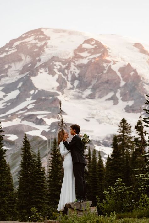 A couple in wedding attire stands on a log in front of Mount Rainier during their Mount Rainier elopement Mt Rainier National Park Wedding, Washington Elopement Photography, Spring Mountain Elopement, Mount Rainier National Park Elopement, Mount Rainier Engagement Photos, Mt Rainier Engagement Photos, Mt Rainier Wedding, Mount Rainier Wedding, Mount Rainier Elopement