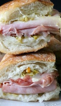 Mini Muffuletta Sandwiches filled with Ham, Salami, Provolone Cheese and a Special Olive Salad and Parmesan Cheese Dip. Muffuletta Recipe, Muffaletta Sandwich, Muffuletta Sandwich, Mardi Gras Food, Desserts Keto, Burgers Sandwiches, Chapati, Soup And Sandwich, Game Day Food