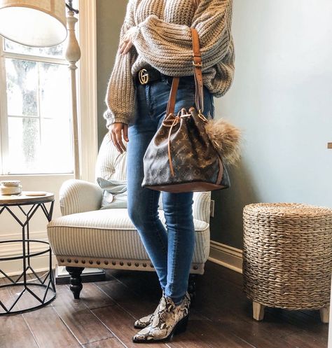 Styled with skinny jeans, snakeskin print boots, Gucci belt, oversized sweater, puff purse charm Lv Noe, Noe Louis Vuitton, Vuitton Outfit, Louis Vuitton Outfit, Louis Vuitton Petit Noe, Print Boots, Boot Print, Vintage Louis Vuitton, Snakeskin Print