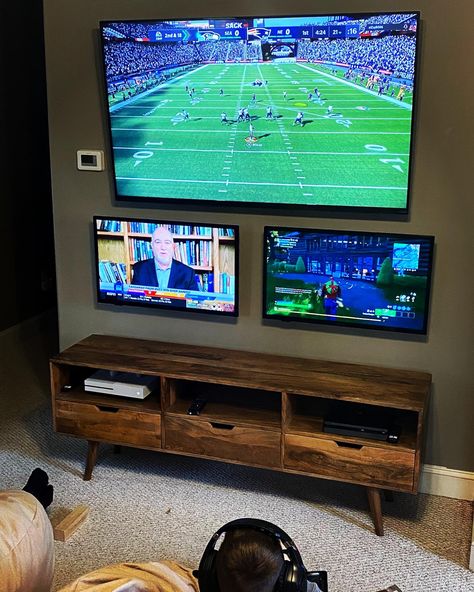 TV wall, Xbox, PlayStation, game room ideas, big Joe bean bags Multi Tv Game Room, Man Cave Multiple Tv Set Up, Man Cave Multiple Tvs, Family Video Game Room, Xbox Tv Setup, 2 Tvs In Game Room, Double Tv Game Room, Sports Game Room Ideas, Two Tv Game Room