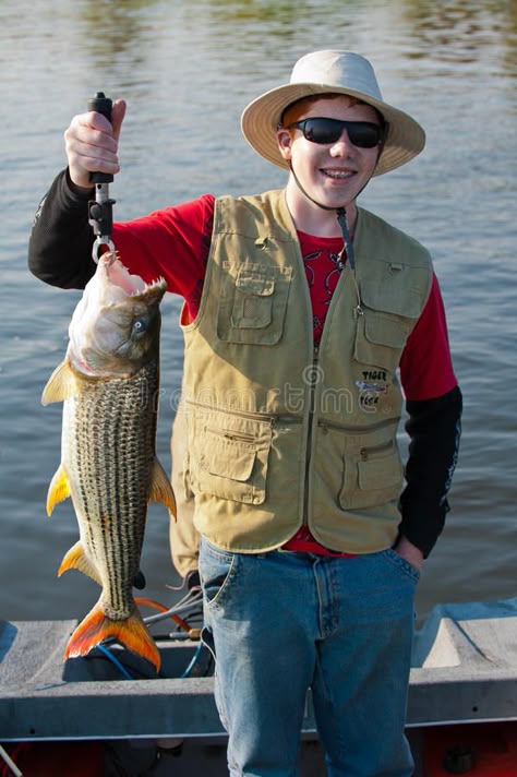 Teenage Fisherman - Tiger Fish. A young lad with his first catch of the mighty T #Sponsored , #SPONSORED, #sponsored, #Fisherman, #Fish, #catch, #Tiger Fisherman Outfit, Tiger Fish, Man Posing, Fish Pose, Fishing Party, Fishing Pictures, Fish Stock, Boy Fishing, Restaurant Management