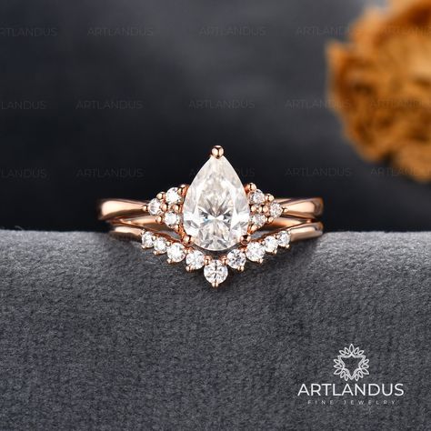 Pear Shaped Moissanite Engagement Ring Rose Gold Ring Set Woman Vintage Tear Drop Bridal Set Cluster Stacking Ring Custom Fit Chevron Band Description: * Handmade, high-quality item * Material: SOLID 14K/18K GOLD ( can be made in yellow/white/rose gold ) Engagement ring: ♡Center stone: Moissanite ♡Size: 6*9mm ♡Weight: about 1.5ct ♡Cut - Pear Shaped ♡ Side Stones: Moissanite or Natural Diamond DE color, VVS clarity ♡ Weight: about 0.15ct ♡ Cut - Round Cut & Marquise Cut ♡ Band Width: Around 1.5mm Wedding Bands With Teardrop Ring, Chevron Engagement Ring Set, Pear Shape Engagement Ring With Wedding Band, Tear Shaped Wedding Rings, Pear Moissanite Engagement Ring Set, Tear Drop Engagement Ring With Wedding Band, Teardrop Diamond Engagement Ring, Chevron Band With Engagement Ring, Moisannite Engagement Rings Pear