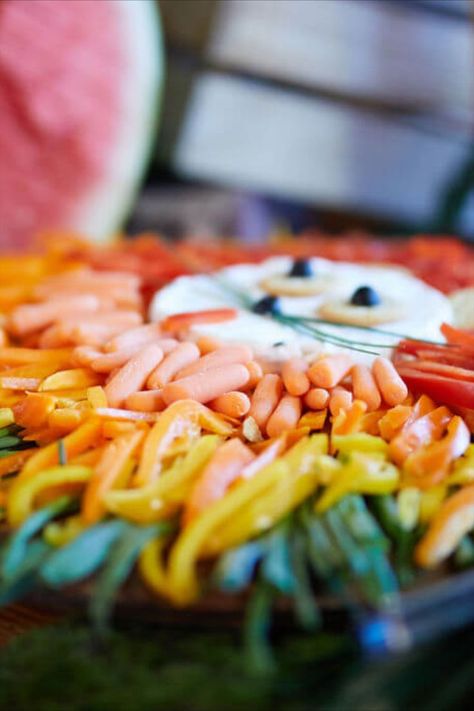 This lion vegetable display for a safari jungle party is one of our favorites! Organize your preferred vegetables in the shape of a lion's mane around the vegetable dip, & you will have all the kids excited to eat their veggies! Serving a variety of easy-to-eat snacks instead of a full meal can be a good option for kids’ birthday parties. We recommend hiring a local caterer like Moonshine and Suppertime to ensure a professional display! Check out our blog for more party planning tips & tricks. Lion Veggie Tray Jungle Party, Safari Jungle Birthday Party, Vegetable Display, Vegetable Dip, Vegetable Tray, Jungle Birthday Party, Eat Snacks, Lion's Mane, Jungle Birthday