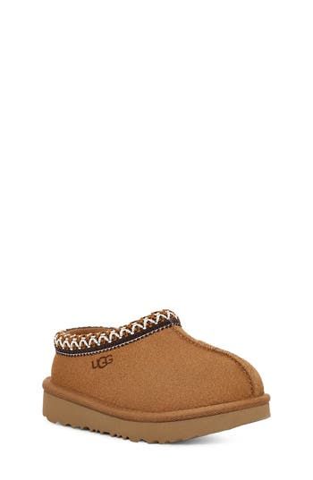 UGG's bestselling slipper is scaled down for kids and lined completely in cozy UGGplush™, a wool-blend textile designed to feel and wear like genuine shearling. Water-resistant Leather upper/UGGplush wool-blend lining/synthetic sole Imported This product was made in a factory that supports women-worker empowerment through HERproject, which creates partnerships to enable workplace-based interventions on health, financial inclusion and gender equality Low Uggs, Kids Ugg Slippers, Cute Uggs, Financial Inclusion, Pretty Shoes Sneakers, Kicks Shoes, Trendy Outfits For Teens, Cute Nike Shoes, Ugg Slippers