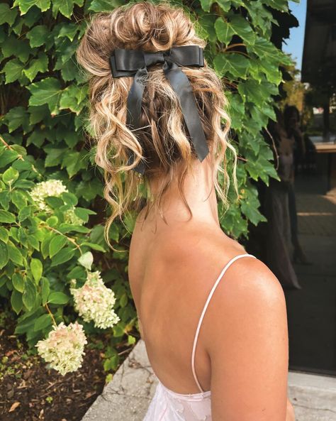 Bun with curles coquette black bow hair styles wedding guest hair styles updo curled hair bow Bow Hairstyle Updo, Hair Bun With Bow, Hair With Big Bow, Updos With Bows, Bun With Bow Hairstyle, Buns With Bows, Wedding Guest Hair Styles, Updo With Bow, Hair Styles Wedding Guest