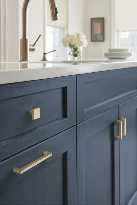 Navy cabinets are very popular, and it's easy to see why. They give kitchens a modern vibe and can feel moody or classy. But what color hardware goes ... | Add Elegance with Champagne Bronze Navy Kitchen Cabinets, Cabinet Hardware Size, Navy Cabinets, Bronze Cabinet Pulls, Navy Kitchen, Bronze Kitchen, Cabinets Drawers, Champagne Bronze, Cabinet And Drawer Pulls