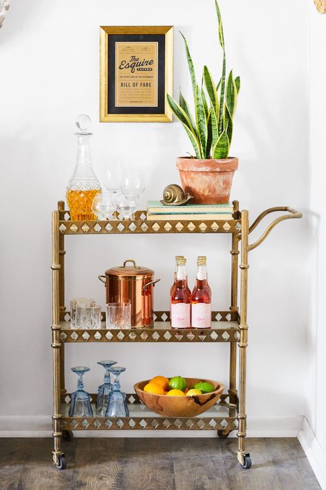 Bar carts serve as stylish yet hardworking hubs for entertaining. Learn how to style your beverage station with these beautiful bar cart ideas. #barcart #barcartstyling #barcartideas #barcartdecor #bhg Bar Cart Ideas, Bar Cart Essentials, Cocktails Cart, Brass Bar Cart, Diy Bar Cart, Gold Bar Cart, Cart Ideas, Types Of Glassware, Martini Shaker