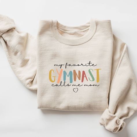 Gymnastics mom sweatshirt, Gymnastics mom shirt, Mom Gymnastics shirt, Gift for Gymnastics mom, gymnastics mom hoodie, proud gymnastics mom, gymnast mom  ♥ WHY YOU WILL LOVE YOUR SWEATSHIRT ♥ * Unique cute gift for everyone that is incredibly easy and stress-free to order & receive * Design is a the words Golden mama writing with trendy retro color and font. * Softest quality 50% cotton, 50% polyester with loose fit that runs true to size (unisex) * Extreme comfort with no bulky side seams for g Gymnastics Family Shirts, Mom Life Shirt Ideas, Cotton Activewear With Letter Print, Cotton Workout Sweatshirt With Letter Print, Cotton Gym Sweatshirt With Letter Print, Letter Print Cotton Sweatshirt For Gym, Cotton Sweatshirt With Letter Print For Workout, Cotton Letter Print Sweatshirt For Gym, Dance Team Shirts