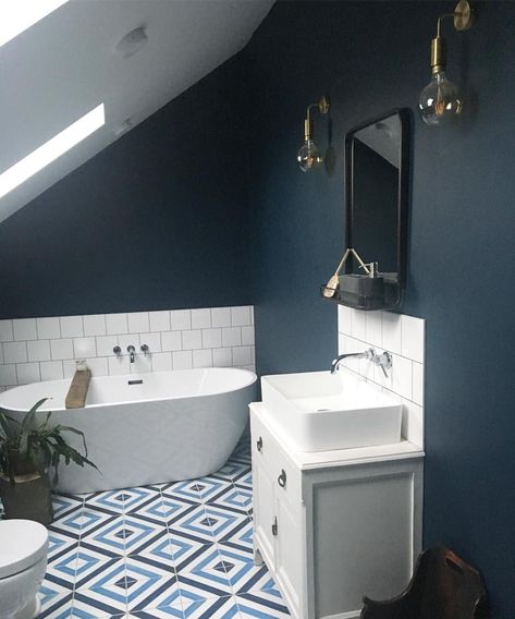 Dark interior walls, Hague blue bathroom. Freestanding bath with geometric cement encaustic tiles. Industrial wall mounted mirror and wall lights sconces. Vintage vanity with stone sink. Square white tiles Hague Blue Bathroom, Blue Bathroom Paint, Blue Bathroom Walls, Dark Blue Bathrooms, Bathroom Under Stairs, Blue Bathroom Tile, Bathroom Freestanding, Toilet Room Decor, Hague Blue