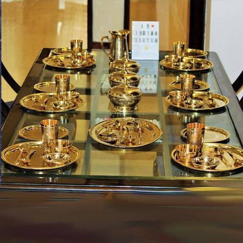 Buy a traditional Brass royal dinner set from Indian Bartan. The 6 Person Royal Brass Dinner Set is made in India with brass. It includes 6 Full Plates,6 Half Plates,6 Glasses,6 Bowls,6 Dish Plates,3 Serving Bowls with lid,1 Rice Plate,1 Jug,12 Spoons,3 Serving Spoons. Indian Kitchen Utensils, Royal Dinner, Quirky Kitchen Decor, Vintage Kitchen Gadgets, Dinnerware Set Modern, Gold Plastic Plates, Serving Bowls With Lids, Crockery Design, Formal Table Setting