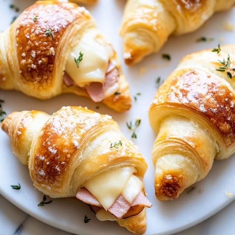 These quick & easy ham and cheese crescent rolls are perfect for a quick weeknight dinner, after-school snack, or party appetizer. Crescent Sandwiches, Ham And Cheese Crescent Rolls, Ham And Cheese Crescent, Sandwich Appetizers, Ham And Cheese Roll Ups, Cheese Crescent Rolls, Appetizer Sandwiches, Cheese Roll, Easy Ham