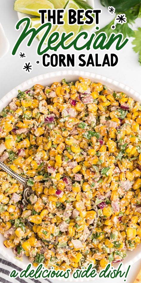 Close-up overhead shot of Mexican corn salad garnished with parsley then topped with Cotija cheese and lime slices. Jalapeno Corn Salad Recipe, Mexican Corn Salad With Fritos, Mexican Corn Skillet, Elote Side Dish, Hot Corn Side Dish, Mexican Street Corn Jalapeno Poppers, Corn And Jalapeno Side Dish, Trader Joes Side Dish Recipes, Sides To Go With Tri Tip