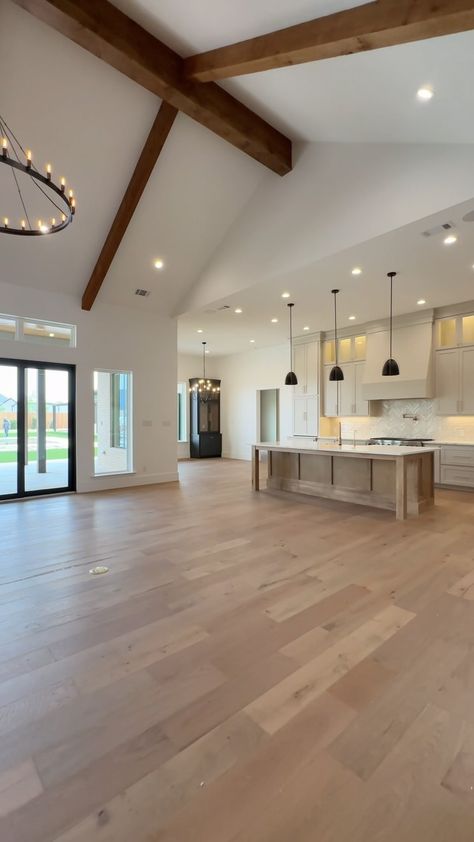 Carrasco Homes | Save for inspo ✨ this stunning open-floor #kitchen, complete with neutral earth-tones, custom lighting, and high-end sterling appliance.... | Instagram Cathedral Ceiling Kitchen Living Room, Kitchen To Living Room Floor Transition, Earth Tone Kitchen, High Ceiling Kitchen, Earth Tones Kitchen, Light Interior Design, Casita Ideas, House With Land, Buy Dirt