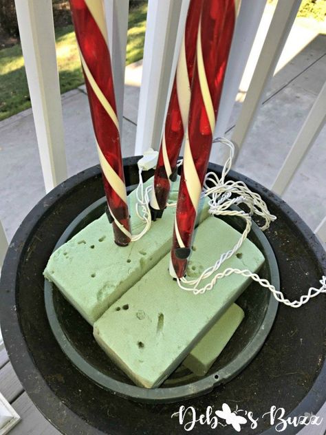 DIY Lighted Candy Cane Christmas Urns Add Whimsy - Debbee's Buzz Outdoor Christmas Decorations Lights, Christmas Candy Cane Decorations, Christmas Urns, Canes Decor, Candy Cane Decorations, Christmas Planters, Front Porch Christmas Decor Ideas, Porch Christmas Decor Ideas, Porch Christmas Decor