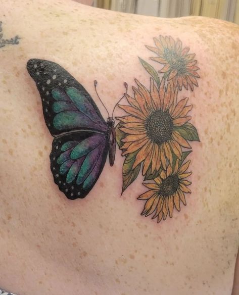 Tattoo of a butterfly / sunflower done by @colleenajsmith. A colourful piece, but more natural than anything. Rich purples and blues filled in the butterfly wing, but soft yellows are the petals of the sunflowers. Butterfly Sunflower Tattoo, Purple Butterfly Tattoo, Butterfly Sunflower, Mama Tried, Sunflower Tattoo, Butterfly Wing, Nature Tattoos, Best Tattoo, Hidden Gem