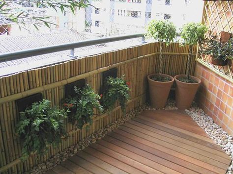 Balcony railing design with bamboo for privacy and to hang planters from. The rock border around the wood flooring gives this just the right finishing touch. Klein Balkon Decor, Balcony Privacy, Balcony Planters, Balcony Flooring, Small Balcony Garden, Balcony Railing Design, Small Balcony Design, Apartment Patio, Small Balcony Decor