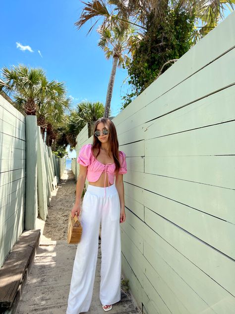 Our One and Only Eyelet Crop Top is truly a one of a kind top you'll never want to take off! This top features stunning eyelet material, fully lined in front, center front tie, semi puff sleeves and smocked back. Pair this top with all your fave denim or linen pants for the chicest summer outfit! Content: 100% Cotton Fit: Runs smaller - can be adjustable by front tie Model wearing size: Small (fits like an XS) Model sizing: 0-2 top, 24" bottoms | Height: 5'3" White Linen Pants Outfit, Goa Outfits, Linen Pants Outfit, White Pants Outfit, Summer Pants Outfits, Summer Shorts Outfits, White Linen Pants, Outfit Inspo Summer, Brunch Outfit