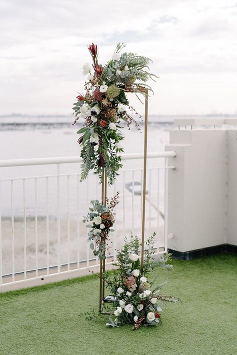 tall gold stand with multiple flower clusters in an asymmetrical design Australian Native Wedding Arch, Australian Native Flowers Wedding, Grit Photography, Wedding Arbours, Ceremony Arbour, Native Bouquet, Navy Blue Suits, Floral Sculptures, Rustic Wedding Flowers Bouquet