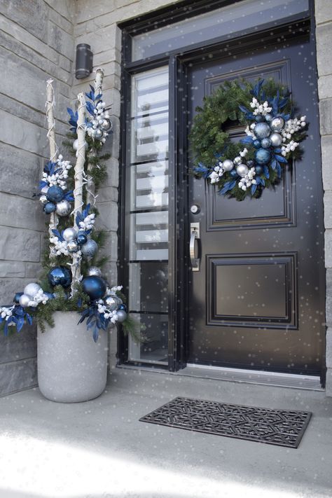 This Christmas, create an entrance to remember! Blue Front Door Christmas Decor, Blue Christmas Diy Decor, Blue Christmas Porch Decor, Blue House Christmas Decor Exterior, Blue Outdoor Christmas Lights, Modern Blue Christmas Decor, Blue Christmas Outdoor Decor, Blue Outdoor Christmas Decor, Entrance Christmas Decorations