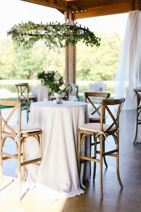 Crossback bar stools, white linens, and greenery for a beautiful cocktail hour. Rentals by Southern Events Party Rental Company | Franklin, Nashville, Middle Tennessee Event Lounge Furniture, Reception Seating Layout, Reception Cocktail Tables, Wedding Cocktail Table, Seating Layout, Wedding Cocktail Tables, Cocktail Table Decor, Table Decoration Ideas, Cocktail Wedding Reception