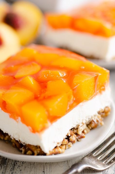 Peach Pretzel Salad Dessert is a fresh summer twist on the classic fruit and jello pretzel dessert using fresh or canned peaches. Jello Pretzel Dessert, Pretzel Salad Dessert, Peach Ideas, Pretzel Jello, Fruit Deserts, Jello Pretzel Salad, Skor Bars, Pretzel Recipes, Pretzel Dessert