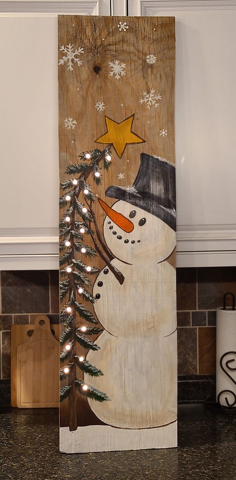 Snowman Painted On Wood Board, Barn Board Christmas Projects, Wood Plank Signs Diy, How To Paint A Snowman On Wood, Paint Snowman On Wood, Fence Board Christmas Projects, Wood Plank Christmas Crafts, Winter Signs Wooden Diy, Wood Painting Christmas