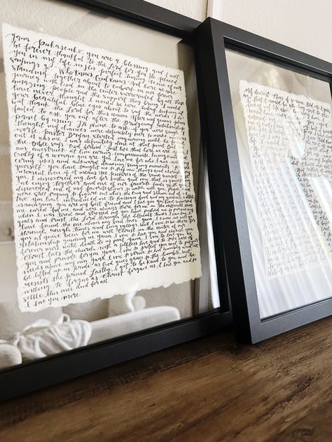 Two black floating frames holding his and hers vows. The vows are scripted on handmade paper with black ink. The frames are beautifully displayed on a table in the living room. Vows Wall Decor, Diy Vows Display, Vows Display Wall Art, Vows Over Bed, Vows On Wall, Wedding Vow Display, Wedding Photo Display Home, Display Vows, Framed Vows