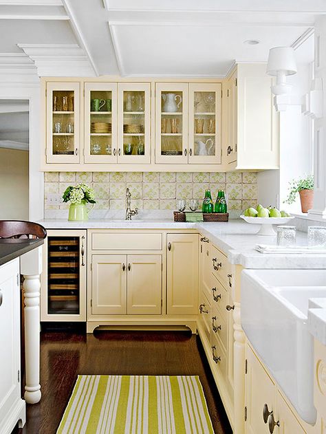 Sweetly Nostalgic Color Scheme -  Evoking nostalgia, this kitchen recalls simpler times  (I'd change the green out and go with blue; but I like the butter-cream color on the cabinets!) Colored Kitchen Cabinets, Cream Colored Kitchens, Cream Colored Kitchen Cabinets, Kitchen Cabinet Color Schemes, Yellow Kitchen Cabinets, Cream Kitchen Cabinets, Colored Kitchen, Yellow Cabinets, Cottage Kitchen Design