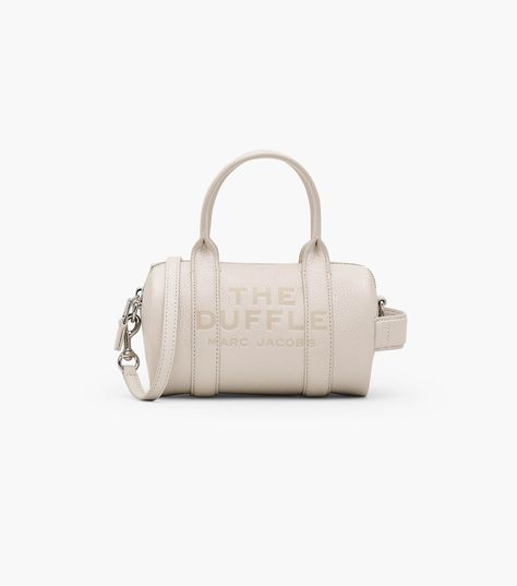 The mini version of our bestselling Duffle Bag is crafted in supple full-grain leather and finished with our signature embossed branding. Shop Marc Jacobs The Leather Mini Duffle Bag Mini Duffle Bag, Buckle Bags, Mini Bucket Bags, Sack Bag, Leather Belt Bag, Crossbody Tote Bag, Metallic Sandals, Leather Bucket Bag, Crossbody Tote