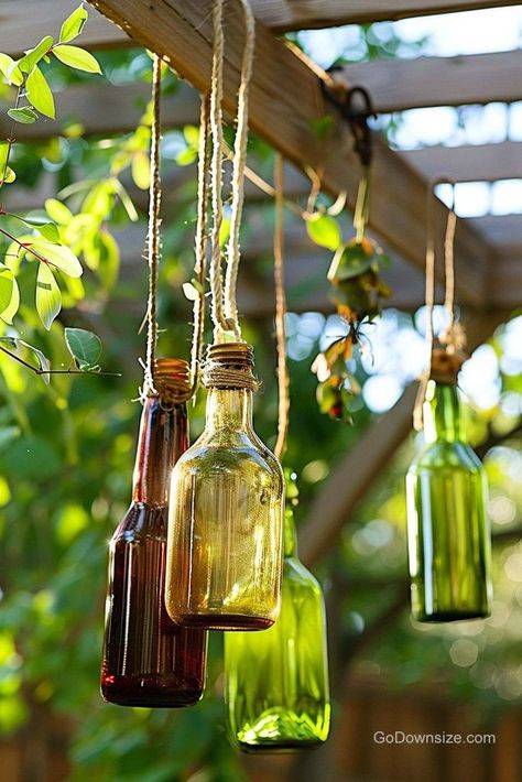 Whether you’re looking for a windchime substitute or just another way to decorate your outdoor space, think about hanging up glass bottles. Hanging Glass Bottles, Garden Decor Ideas, Bottle Garden, Glass Bottles Decoration, House Plant Care, Look Beautiful, Horticulture, Glass Bottle, Plant Care