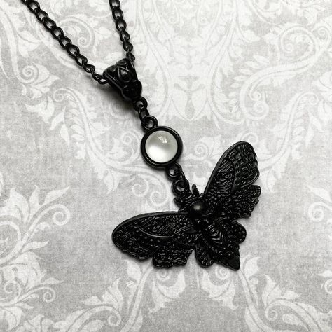 Gothic Black Moth Necklace Embrace the allure of the night with our Gothic Black Moth Necklace, a symbol of mystery and elegance. Crafted with intricate detail and dark charm, this necklace captures the essence of Gothic aesthetics. ✈️Free Shipping worldwide. 👉Our shop: gothickawaii.com Gothic Choker Necklace, Moth Necklace, Gothic Kawaii, Open Wings, Resin Cabochon, Halloween Pendant, Gothic Chokers, Hawk Moth, Skull Pattern