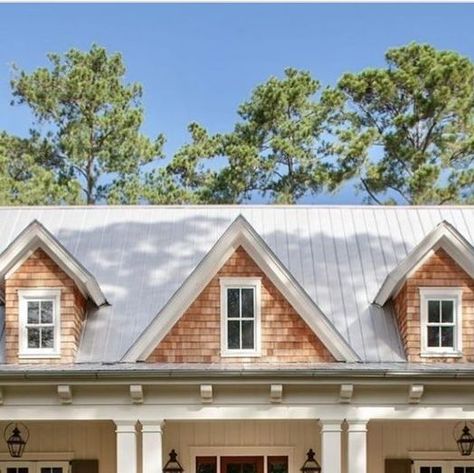 Tamra Lea #Itsahouselovestory on Instagram: "A large and inviting front porch, metal roof, white board and batten siding and contrasting natural cedar shingles on the dormers make for attractive curb appeal. 

Photo: John McManus Fine Art

Original Design by : @courtatkinsgroup

#itsahouselovestory #homedesign #exterior #exteriordesign #archidesign #home #houseandhome #curbappeal #residentialdedign #housedesign" Gables On House Exterior, Porch Metal Roof, White Board And Batten Siding, House With Front Porch, White Board And Batten, Coastal Home Exterior, Cedar Shingle Siding, Metal Roof Houses, Board And Batten Exterior